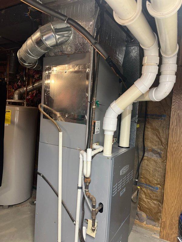 Completed full HVAC system replacement due to R22 refrigerant depletion in existing air conditioning unit. Installed new high-efficiency furnace with proper PVC venting system and matching air handler unit secured to basement wall with appropriate mounting hardware and refrigerant line connections. System commissioned and tested for proper operation.