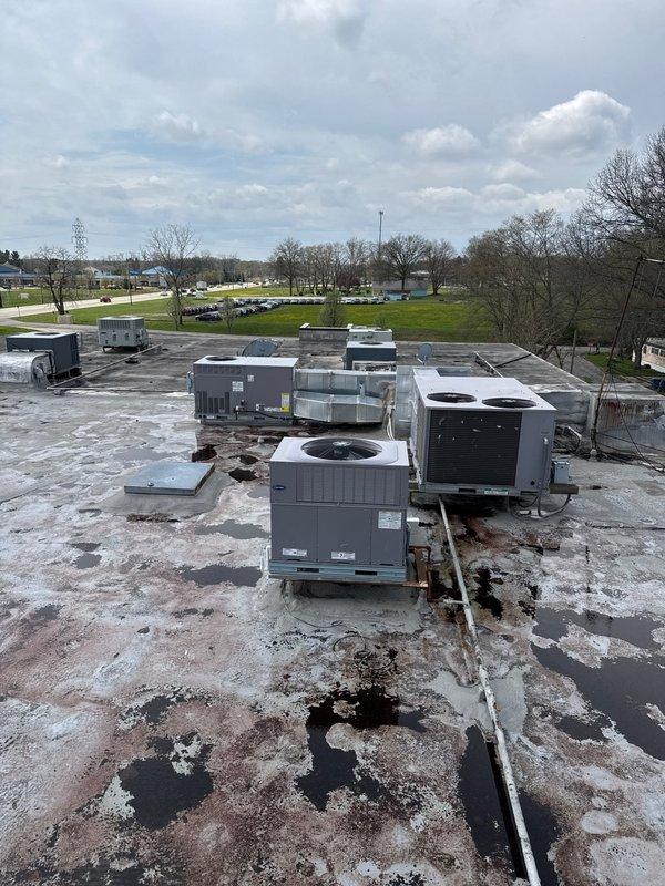 # HVAC New Construction Install - Commercial

Completed installation of multiple rooftop HVAC package units on commercial building flat roof. Installed six to eight rooftop units of varying tonnage, including package units and air handling systems, positioning equipment according to engineered specifications and load-bearing requirements. All units were set on appropriate curb adapters with proper flashing and weatherproofing to prevent water intrusion. Electrical connections, refrigerant lines, and condensate drainage were completed per code requirements. Units were charged, tested, and commissioned to verify proper operation of all heating and cooling functions. System startup procedures confirmed correct airflow, temperature differentials, and control sequences across all installed equipment.