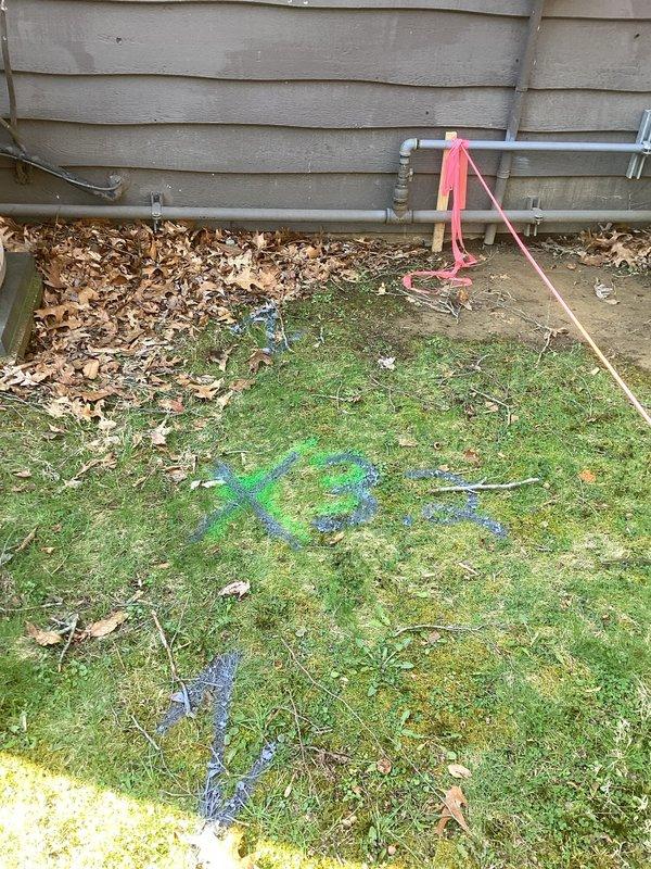 Completed utility line location and marking service in preparation for excavation work. Used electronic locating equipment to identify and mark underground water and gas lines with blue and green spray paint indicators, with pink flagging tape placed on exposed exterior piping to designate active plumbing infrastructure requiring protection during upcoming ground work.