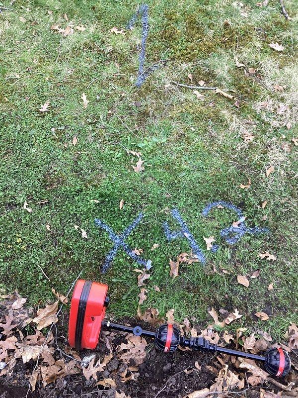 Completed utility line location and marking service in preparation for excavation work. Used electronic locating equipment to identify and mark underground water and gas lines with blue and green spray paint indicators, with pink flagging tape placed on exposed exterior piping to designate active plumbing infrastructure requiring protection during upcoming ground work.