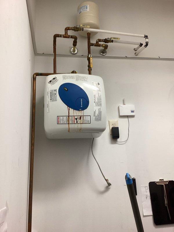 Conducted on-site evaluation of existing water heater system for replacement estimate. Assessed current installation including white tank-style water heater with expansion tank, copper supply piping with multiple shut-off valves, and PVC venting configuration. Documented existing plumbing connections, electrical requirements, valve placements, and overall system condition. Photographed installation setup to provide accurate replacement specifications and pricing options for new water heater unit.