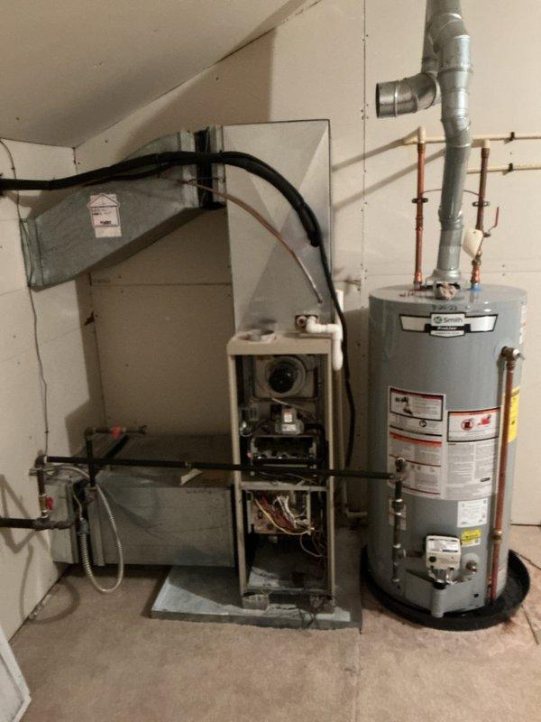 Completed full installation of new Lennox furnace system with integrated air quality components in residential basement mechanical room. Installed air scrubber and air cleaner units to enhance indoor air quality and filtration capabilities. Connected all necessary ductwork, including metallic supply ducts and flexible return connections, ensuring proper airflow distribution throughout the system. Mounted digital thermostat control on wall for system operation and temperature management. Completed all electrical connections to dedicated circuit box, verified proper voltage and amp draw. Installed humidifier unit with water supply line connections for whole-home humidity control. Secured all refrigerant lines, condensate drainage, and gas supply connections per manufacturer specifications and local code requirements. Tested all safety controls including limit switches, pressure switches, and flame sensors to confirm proper operation. Verified furnace ignition sequence, blower motor opera