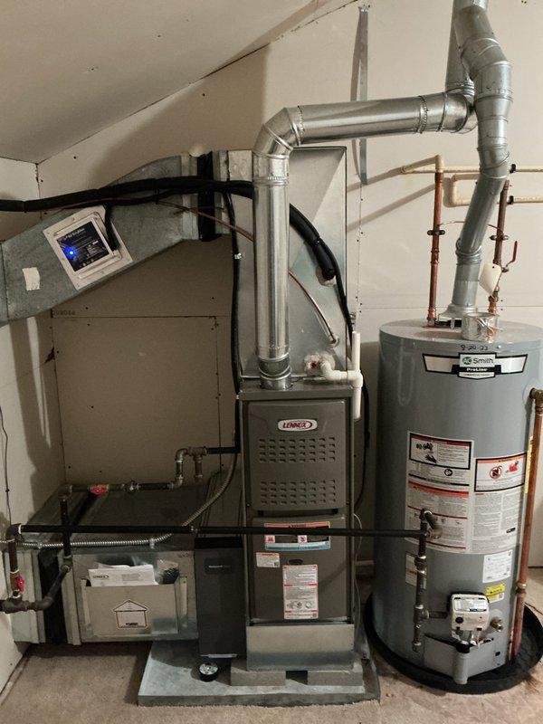 Completed full installation of new Lennox furnace system with integrated air quality components in residential basement mechanical room. Installed air scrubber and air cleaner units to enhance indoor air quality and filtration capabilities. Connected all necessary ductwork, including metallic supply ducts and flexible return connections, ensuring proper airflow distribution throughout the system. Mounted digital thermostat control on wall for system operation and temperature management. Completed all electrical connections to dedicated circuit box, verified proper voltage and amp draw. Installed humidifier unit with water supply line connections for whole-home humidity control. Secured all refrigerant lines, condensate drainage, and gas supply connections per manufacturer specifications and local code requirements. Tested all safety controls including limit switches, pressure switches, and flame sensors to confirm proper operation. Verified furnace ignition sequence, blower motor opera