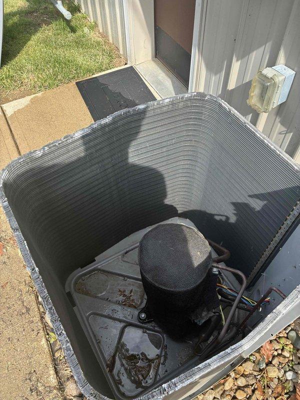 Completed spring maintenance on commercial outdoor air conditioning condenser unit. Performed comprehensive system inspection including visual assessment of condenser coils, which showed moderate accumulation of dirt, grime, and surface discoloration requiring attention. Checked all electrical connections, disconnect box, and conduit mounting at exterior wall. Inspected compressor, refrigerant lines, and internal components for proper operation and signs of wear. Verified unit mounting on concrete pad and surrounding area conditions. System operational upon completion of scheduled maintenance protocol.