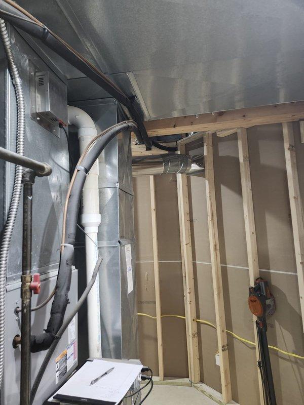 Completed full second-floor air conditioning system replacement including outdoor condensing unit and indoor evaporator coil. Installed new condenser on existing rock pad against building exterior with proper clearances, connected refrigerant line sets with fresh insulation, and mounted weatherproof electrical disconnect box on exterior wall. Inside mechanical space, installed new evaporator coil with air handler unit, ran condensate drain lines using PVC piping, and completed all electrical connections and ductwork integration to existing distribution system.