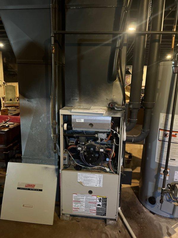 Completed full HVAC system retrofit including replacement of gas furnace and air conditioning condenser unit. Installed new Lennox furnace with updated ductwork connections and venting system, along with new outdoor AC condenser positioned on concrete pad with proper refrigerant line routing and electrical disconnect. All components tested and operational upon completion.