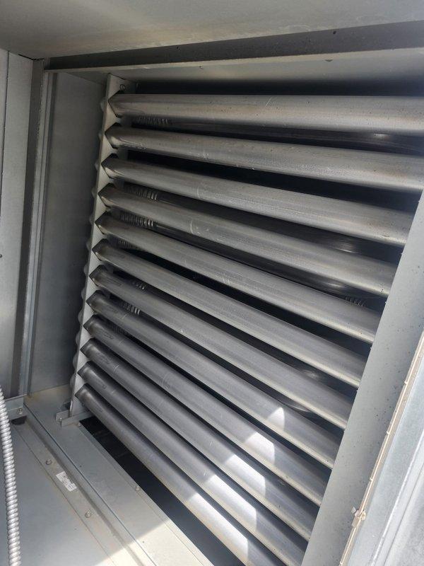 Performed routine maintenance inspection on makeup air unit per customer request. Verified operation of blower motor, fan assembly, and heat exchanger components. Documented equipment condition with photos showing interior cabinet components, motor mounting, and heat exchanger tube assembly in satisfactory operating condition.