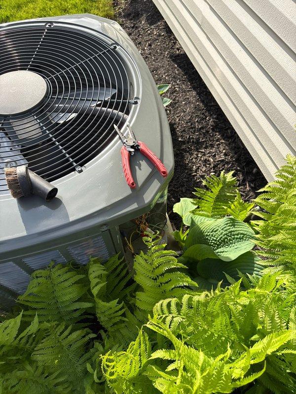 Completed comprehensive spring maintenance on residential outdoor air conditioning condenser unit. Performed thorough system inspection, cleaned condenser coils, verified proper refrigerant levels, tested electrical components, and confirmed optimal airflow through the unit's top-mounted fan assembly. Unit operating efficiently with all components functioning within normal parameters.