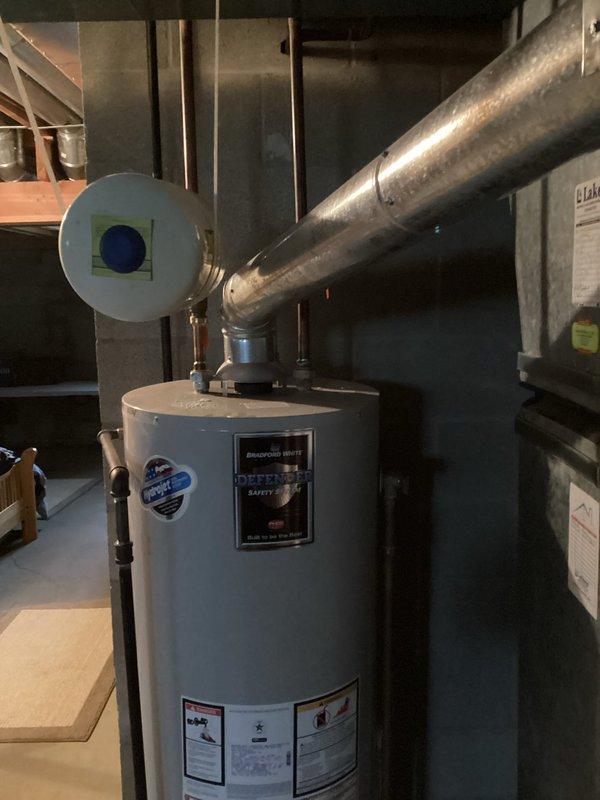Responded to service call for evaluation of failing 50-gallon tanked water heater with defective air tank and active leak. Conducted on-site inspection and documented existing unit condition, including all manufacturer specifications, plumbing connections, venting configuration, and installation setup in basement utility area. Assessed current water heating capacity requirements and discussed options for potential capacity upgrade with homeowner. Photographed existing equipment, piping connections, exhaust venting, and surrounding utility space to facilitate accurate replacement estimate preparation. Provided professional recommendations for new water heater installation based on household needs and existing infrastructure.