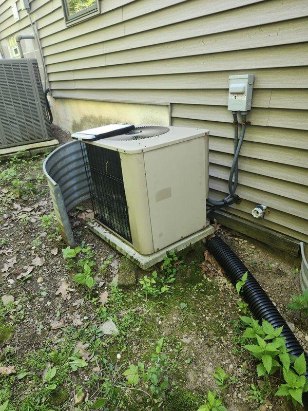 Completed AC retrofit installation at residential property. Removed existing HVAC equipment and installed new air conditioning condenser unit with matching evaporator coil system. Positioned condenser on equipment pad against exterior wall with proper clearances, installed electrical disconnect box with conduit connections, and ran refrigerant line set between outdoor and indoor components. Verified proper drainage routing, tested system operation, and confirmed all electrical connections meet code requirements.