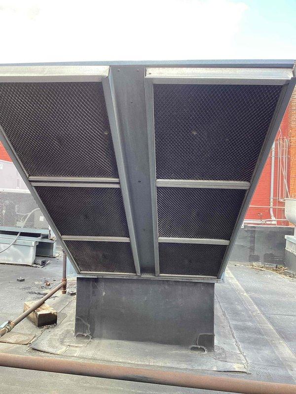 Completed scheduled commercial cooling maintenance visit on rooftop HVAC unit. Performed system inspection of large commercial air handling equipment, checking operational status and filter conditions. Replaced dirty air filters with new pleated media filters to maintain proper airflow and system efficiency. Documented equipment condition through photographic records showing rooftop unit configuration and filter replacement. Unit operational with improved air filtration following maintenance completion.