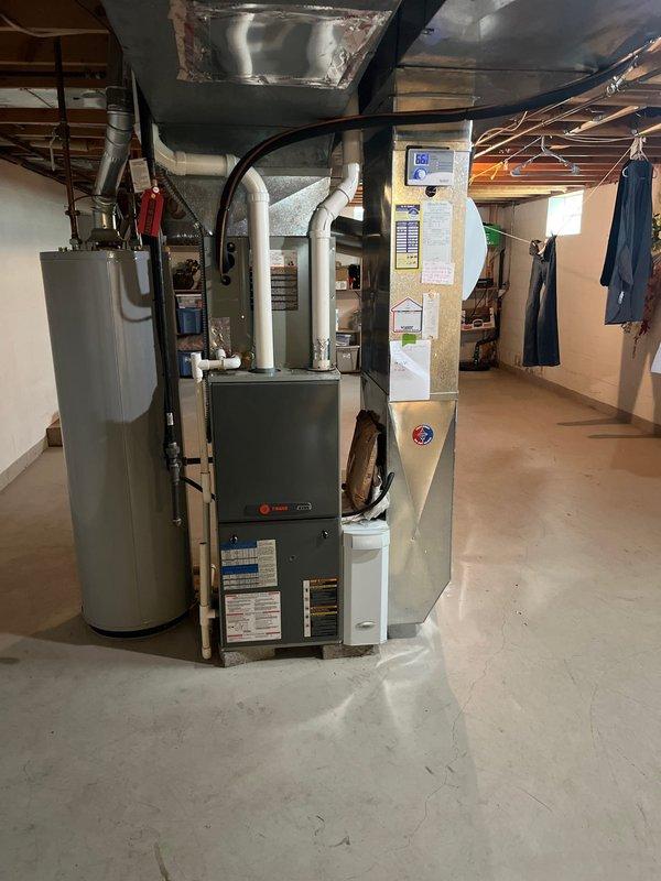 Completed full HVAC system replacement including outdoor condensing unit and indoor furnace. Installed new Trane air conditioning condenser on existing concrete pad with proper refrigerant line connections through exterior brick wall. Replaced indoor furnace unit in basement mechanical room with new equipment, ensuring proper integration with existing ductwork and utility connections. All components installed to manufacturer specifications and tested for proper operation.