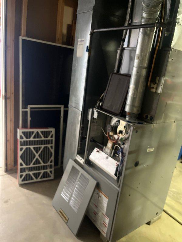 Completed comprehensive HVAC system assessment for air conditioning retrofit in residential basement utility space. Evaluated existing furnace and air handler configuration, including ductwork connections, electrical components, and system accessibility for planned AC integration. Documented current equipment layout, clearances, and mechanical room conditions to determine optimal retrofit approach for new cooling system installation.