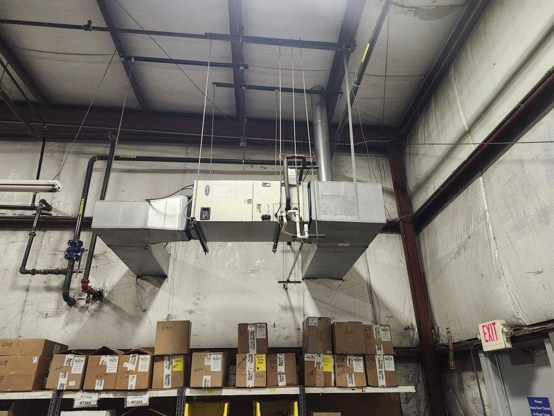 Completed scheduled commercial cooling maintenance on warehouse HVAC system, including inspection of ceiling-mounted air handling unit and outdoor condenser unit. All equipment inspected and found operating within normal parameters, with both indoor and outdoor components showing proper installation and secure mounting. System confirmed operational for continued climate control of commercial storage facility.