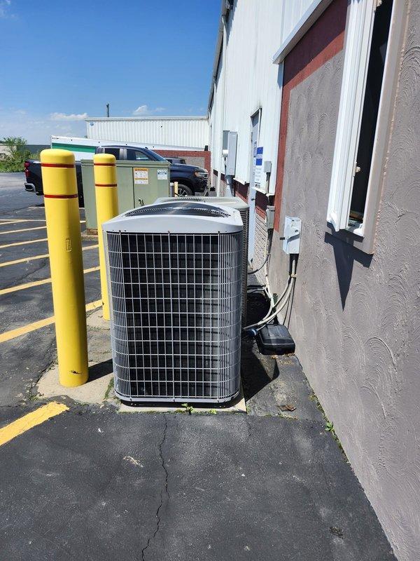 Completed scheduled commercial cooling maintenance on warehouse HVAC system, including inspection of ceiling-mounted air handling unit and outdoor condenser unit. All equipment inspected and found operating within normal parameters, with both indoor and outdoor components showing proper installation and secure mounting. System confirmed operational for continued climate control of commercial storage facility.