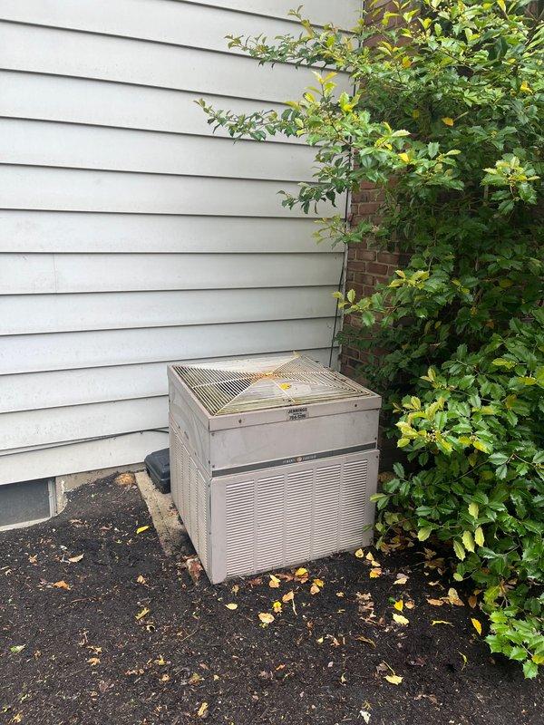 Conducted comprehensive HVAC system assessment for complete air conditioning and furnace retrofit. Evaluated existing outdoor condenser unit positioned on exterior asphalt pad against white vinyl siding, and inspected basement furnace installation with associated ductwork and utility connections. Documented current equipment specifications, measured existing installation parameters, and photographed system components to develop detailed replacement proposal. As final contractor providing estimate, presented competitive retrofit solution addressing complete system upgrade requirements including proper sizing, efficiency improvements, and code compliance considerations for both cooling and heating equipment replacement.