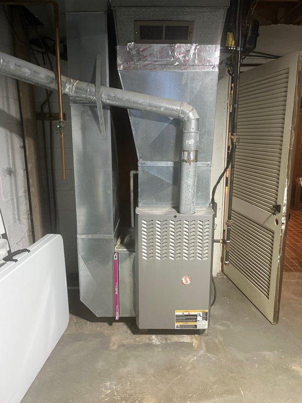 Conducted comprehensive HVAC system assessment for complete air conditioning and furnace retrofit. Evaluated existing outdoor condenser unit positioned on exterior asphalt pad against white vinyl siding, and inspected basement furnace installation with associated ductwork and utility connections. Documented current equipment specifications, measured existing installation parameters, and photographed system components to develop detailed replacement proposal. As final contractor providing estimate, presented competitive retrofit solution addressing complete system upgrade requirements including proper sizing, efficiency improvements, and code compliance considerations for both cooling and heating equipment replacement.