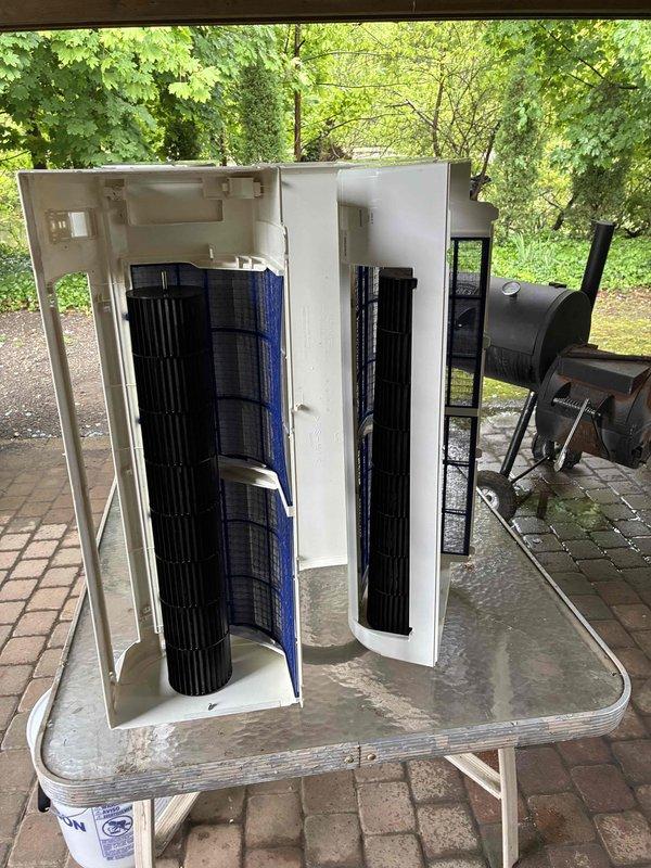 Performed contracted maintenance on commercial HVAC air handler units. Removed blower wheel assemblies from cabinets and transported to outdoor workspace for thorough cleaning. Disassembled front access panels to extract cylindrical cross-flow blower wheels, which were cleaned to remove accumulated dirt and debris. Documented condition of components with photos during maintenance process. Units staged on work table for reassembly after cleaning was completed.
