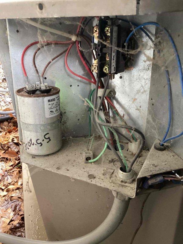Completed spring maintenance on commercial outdoor air conditioning condenser unit. Performed comprehensive inspection of electrical components within control panel, including MARS capacitor and wiring connections at terminal block. Cleaned and evaluated exterior condenser unit with fan assembly and housing. All components inspected for proper operation and seasonal readiness.