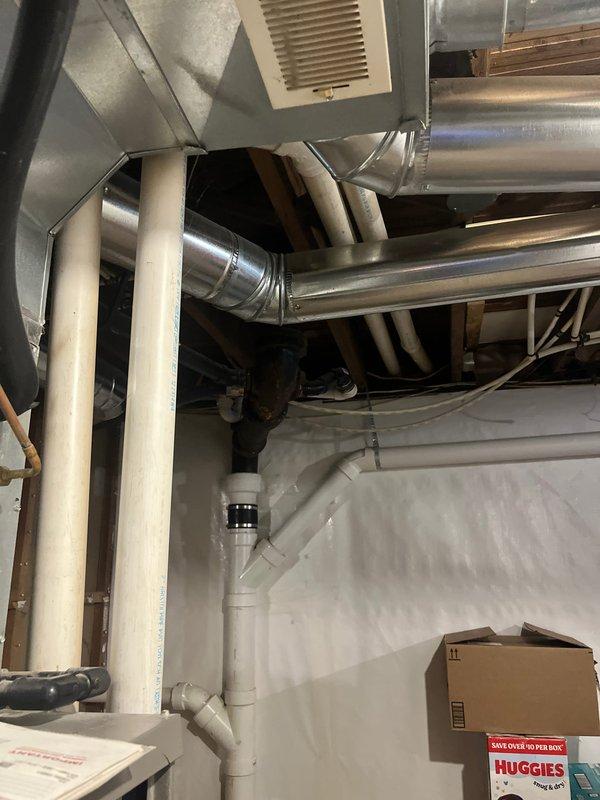 Completed full HVAC system replacement in residential basement mechanical room. Removed existing heating and cooling equipment and installed new furnace and air conditioning system with corresponding ductwork modifications. All new metallic ductwork properly sealed and connected to ensure optimal airflow throughout the home, with PVC condensate drainage lines installed per manufacturer specifications and local code requirements.