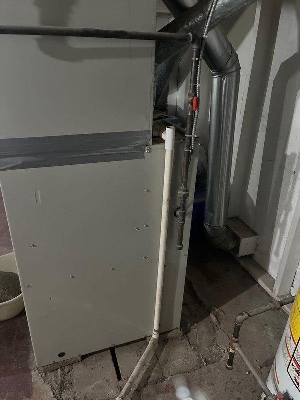 Conducted comprehensive assessment of existing residential HVAC system for complete furnace and air conditioning replacement. Evaluated current forced-air heating system with beige cabinet furnace unit installed in basement utility area, including existing ductwork configuration and connections. Assessed outdoor air conditioning unit placement relative to patio area and determined requirements for relocation to improve aesthetics and functionality. Documented existing equipment specifications, ductwork routing through cylindrical supply ducts, and current mechanical room layout including water heater proximity and available space constraints. Provided detailed retrofit estimate for new furnace and AC system installation with outdoor unit repositioning away from patio area per customer request.