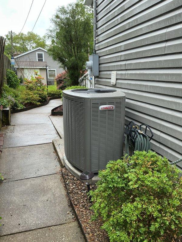 Completed full AC retrofit installation including new outdoor condensing unit and indoor evaporator coil. Installed Lennox outdoor unit on concrete pad alongside residence with proper clearances maintained from structure and landscaping. Unit positioned on existing concrete pad with level installation verified. Connected refrigerant lines using insulated linesets, secured with appropriate hangers and protection. Routed electrical connections through conduit to indoor air handler location, terminating at junction box with proper strain relief and code-compliant wiring methods. Installed new evaporator coil at indoor air handler, integrating with existing ductwork. Completed all refrigerant line connections with brazed joints, pressure tested system, evacuated to manufacturer specifications, and charged with proper refrigerant type and quantity per unit nameplate. Secured all electrical wiring and refrigerant lines with cable ties and protective sleeving. Verified all safety labels and e