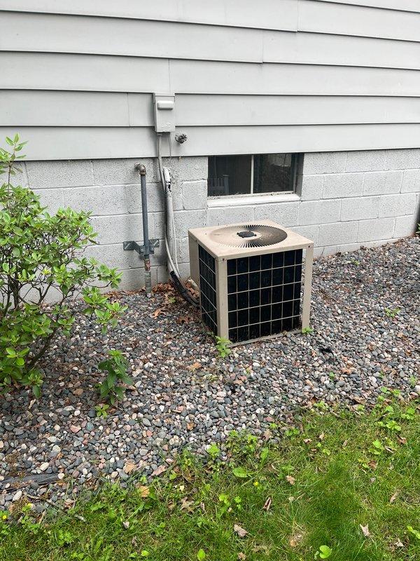 Completed full HVAC system replacement including outdoor condensing unit and indoor water heater. Installed new air conditioning condenser on gravel pad against building foundation with proper condensate drainage via PVC piping, and replaced water heater in utility closet with new unit featuring copper piping, brass fittings, pressure relief valve assembly, and expansion tank. All components properly connected, tested, and verified operational.