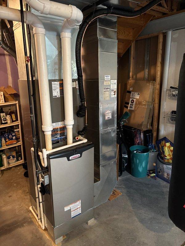 Completed full HVAC system replacement including new Lennox furnace and air conditioning unit. Installed furnace in basement utility area with proper PVC condensate drain configuration, connected metal and flexible ductwork, and performed comprehensive leak test on refrigerant system using digital manifold gauges, achieving passing results with 0.2% pressure drop over five-minute test period at 299.6 psig.