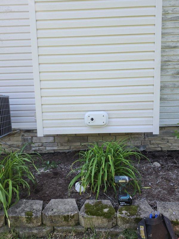 Completed HVAC warranty installation inspection at residential property. Verified proper operation and placement of outdoor condensing unit adjacent to home foundation, confirmed electrical connections to exterior-mounted components, and documented system installation in landscaped area with appropriate clearances maintained per manufacturer specifications.