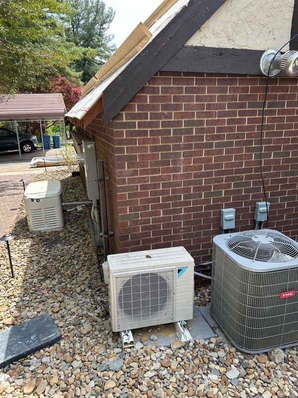 Removed damaged refrigerant lines and line cover assembly from exterior wall to provide access for soffit repair work on residential property. Temporarily relocated HVAC line sets to facilitate carpentry repairs on gable end structure, ensuring existing multi-unit system configuration remained protected during construction phase.