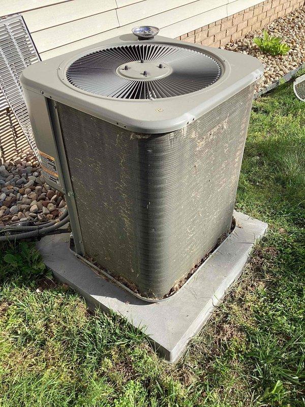 Completed bi-annual preventative maintenance on a 17-year-old residential air conditioning system. Performed comprehensive tune-up including inspection of outdoor condenser unit, verified proper operation of fan motor and compressor, checked refrigerant levels, cleaned condenser coils, and assessed overall system performance. Unit showed age-appropriate wear with exterior weathering and minor surface corrosion on cabinet, but all components functioning within normal parameters at time of service.