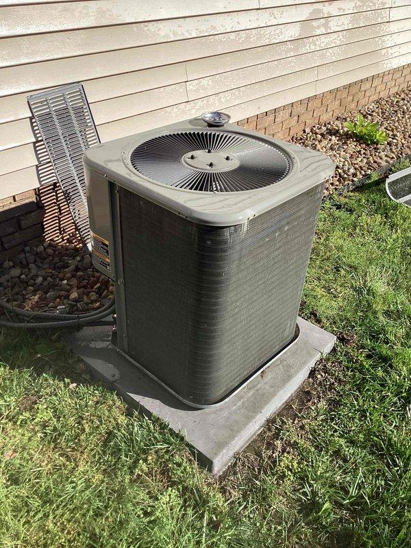Completed bi-annual preventative maintenance on a 17-year-old residential air conditioning system. Performed comprehensive tune-up including inspection of outdoor condenser unit, verified proper operation of fan motor and compressor, checked refrigerant levels, cleaned condenser coils, and assessed overall system performance. Unit showed age-appropriate wear with exterior weathering and minor surface corrosion on cabinet, but all components functioning within normal parameters at time of service.
