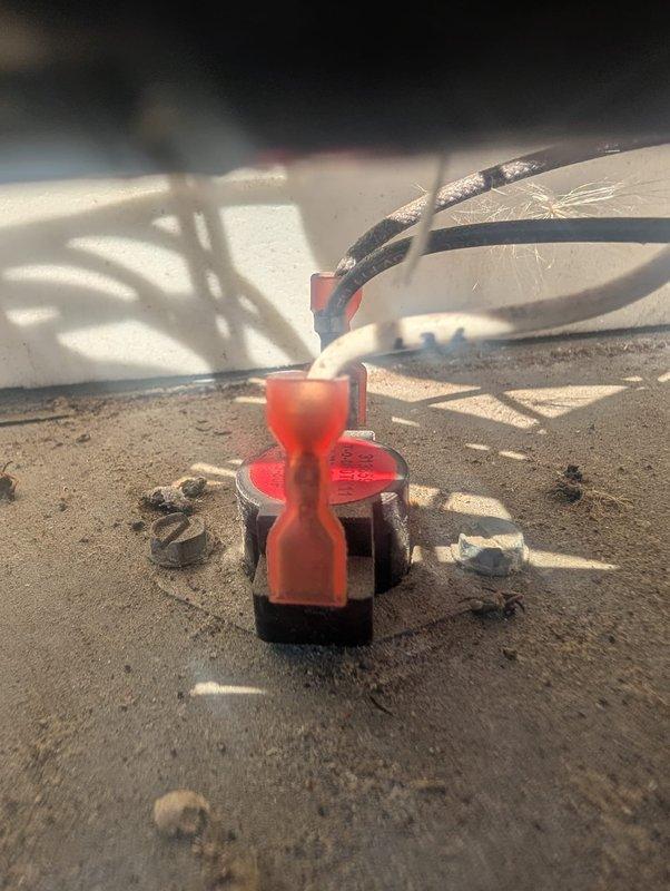 Responded to callback for recurring electrical issue. Inspected and documented wiring connections at terminal blocks, finding accumulated dust and debris on components. Verified wire terminations at red connector blocks and conduit attachment points, checking for loose connections or degradation that could cause repeated system failures.