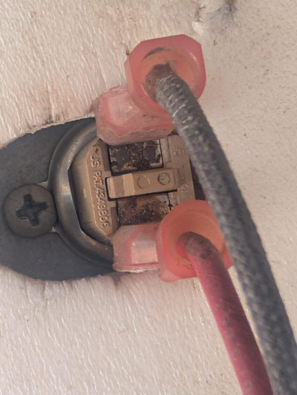 Responded to callback for recurring electrical issue. Inspected and documented wiring connections at terminal blocks, finding accumulated dust and debris on components. Verified wire terminations at red connector blocks and conduit attachment points, checking for loose connections or degradation that could cause repeated system failures.