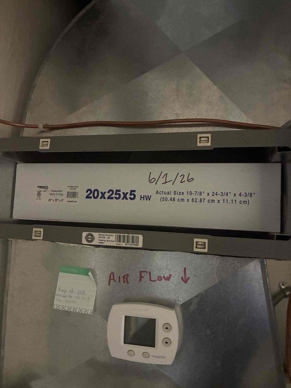 Completed comprehensive AC tune-up on 20-year-old air conditioning system. Inspected outdoor condenser unit, noting weathering and minor algae growth on casing and base pad. Verified proper airflow direction on 20x25x5 air filter assembly within ductwork, documented filter replacement date, and confirmed thermostat control operation. System operational and functioning within normal parameters for unit age.
