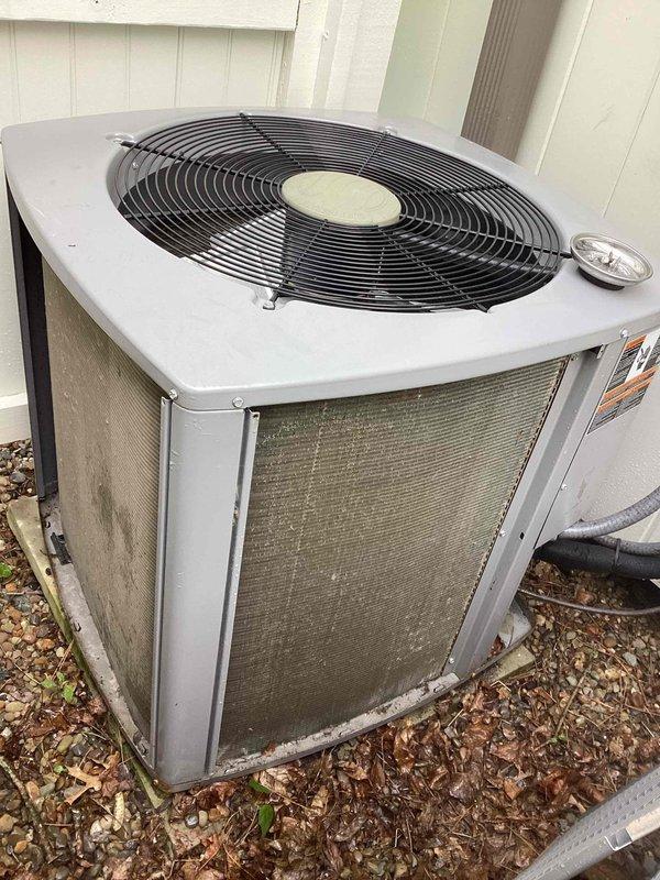 Performed comprehensive air conditioning tune-up and maintenance on multi-split HVAC system consisting of four outdoor condenser units, including two ground-level units and two elevated units requiring ladder access. Completed thorough inspection of all equipment, cleaned condenser coils showing significant dirt and debris accumulation, verified refrigerant levels and pressures, tested electrical connections and capacitors, and inspected air filters which were found to be in clean condition. All units operational and running within manufacturer specifications upon completion of preventive maintenance service.
