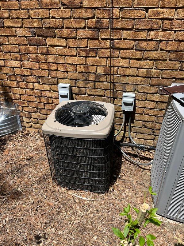 Completed full HVAC system retrofit installation including new furnace and air conditioning unit. Interior installation features new gray metal furnace with integrated humidifier system, PVC venting, insulated flexible ductwork, and proper electrical connections with conduit routing. Exterior installation includes new residential condenser unit with electrical disconnect boxes and conduit properly mounted to brick wall. All components installed to manufacturer specifications with appropriate drainage, venting, and electrical connections verified operational.