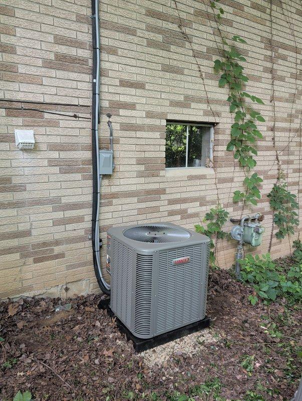 Completed full HVAC system retrofit including new air handler and air conditioning condenser unit. Installed outdoor condensing unit on prepared pad with proper clearances from structure, ran new electrical conduit and disconnect box, and established refrigerant line connections between outdoor unit and air handler. All components properly mounted, leveled, and secured with electrical connections completed to code specifications.