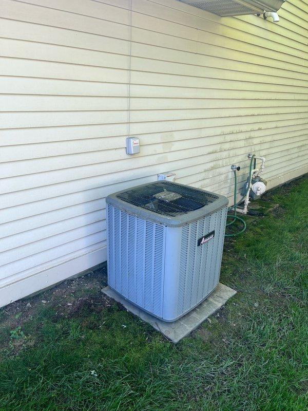 Completed comprehensive HVAC system evaluation for residential air conditioning replacement estimate. Documented existing outdoor condenser unit positioned on concrete pad against exterior wall and indoor air handler installation in mechanical room, including all associated refrigerant lines, ductwork, PVC drainage systems, and electrical connections to provide accurate replacement specifications and equipment recommendations.
