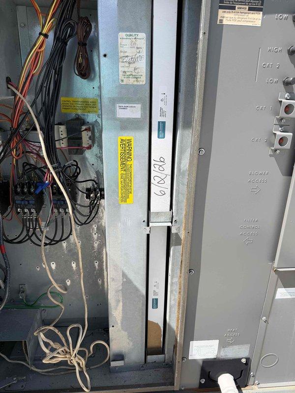 Completed scheduled commercial cooling maintenance visit on rooftop HVAC unit. Inspected multi-filter air filtration assembly and noted moderate dust and debris accumulation across pleated filters with varying levels of loading. Accessed electrical control panel and verified wiring connections, contactors, and safety disconnect functionality. All electrical components operating within normal parameters with warning labels intact and visible.