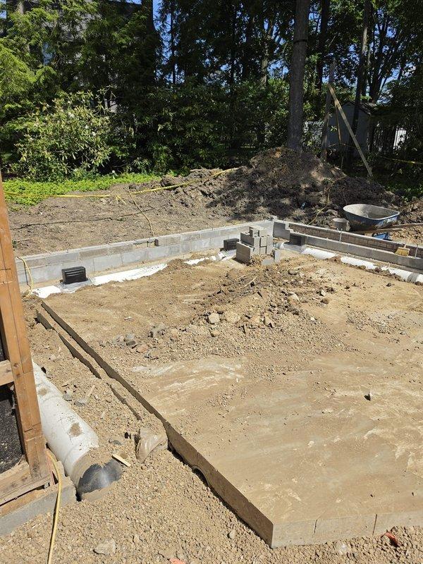 Completed HVAC rough-in installation for new residential construction foundation phase. Coordinated underground ductwork placement and drainage line routing through freshly poured concrete slab and foundation walls, ensuring proper clearances and structural penetrations per building specifications. All rough-in components positioned and verified before concrete finishing and framing phases commence.