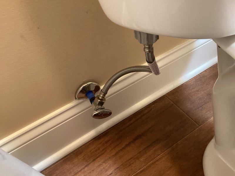 Completed installation of new American Standard toilet in residential bathroom. Removed existing toilet and installed replacement unit with new wax ring seal and closet bolts. Connected water supply using braided stainless steel flex line to chrome angle stop valve with compression fittings. Tested toilet for proper operation, flushing performance, and verified no leaks at tank-to-bowl connection, supply line connections, and base seal. Additionally installed customer-supplied showerhead in bathtub area. All fixtures tested and left in proper working condition.