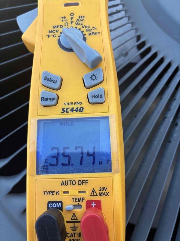 Completed spring maintenance on commercial HVAC unit. Performed comprehensive system inspection and testing of electrical components using digital multimeter. Verified capacitor readings at 35.14 MFD and measured voltage at 5.09 volts on system components. Inspected condenser coil fins, which were found to be clean and in good operational condition. All measurements within normal operating parameters. Unit operating properly upon completion of preventive maintenance service.