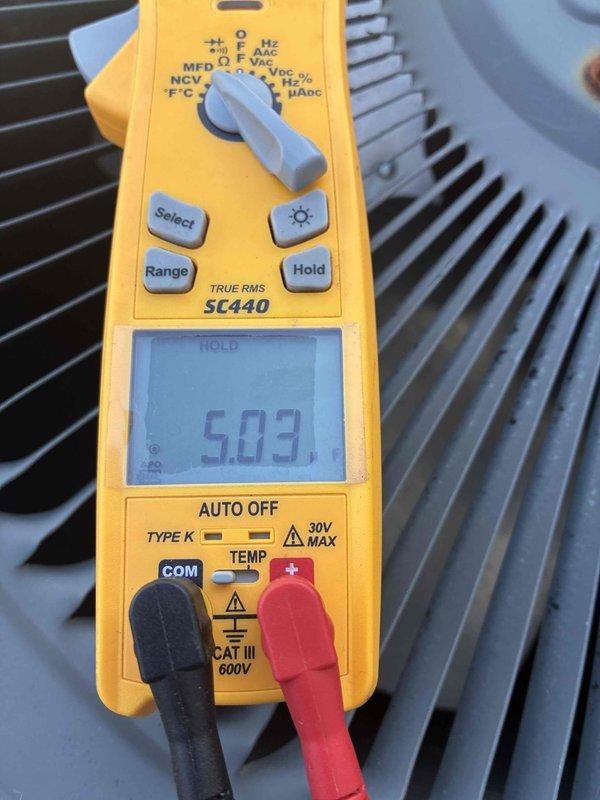 Completed spring maintenance on commercial HVAC unit. Performed comprehensive system inspection and testing of electrical components using digital multimeter. Verified capacitor readings at 35.14 MFD and measured voltage at 5.09 volts on system components. Inspected condenser coil fins, which were found to be clean and in good operational condition. All measurements within normal operating parameters. Unit operating properly upon completion of preventive maintenance service.
