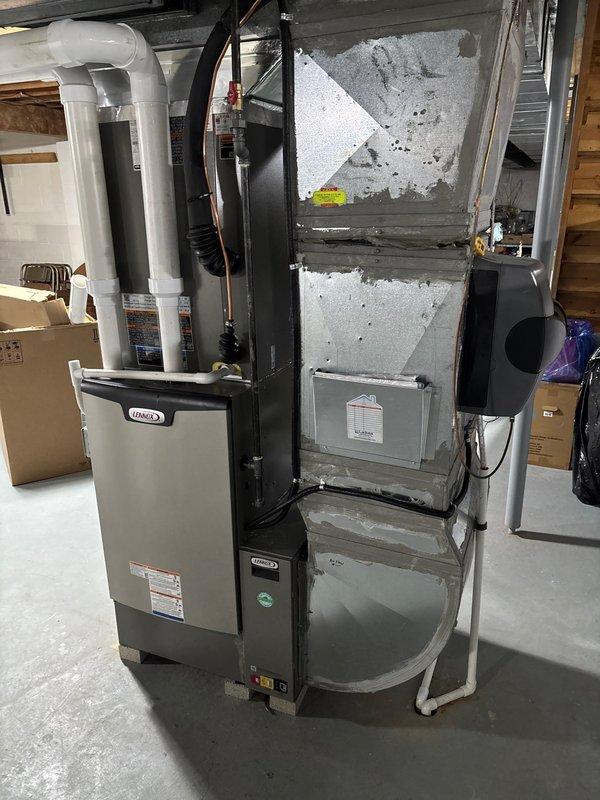Completed full HVAC system replacement in residential basement, installing new high-efficiency furnace and air conditioning system. Configured all ductwork connections, PVC venting, condensate drainage lines, refrigerant lines, and electrical controls to manufacturer specifications. System tested and verified operational, with all components properly mounted and secured on concrete pad in utility area.