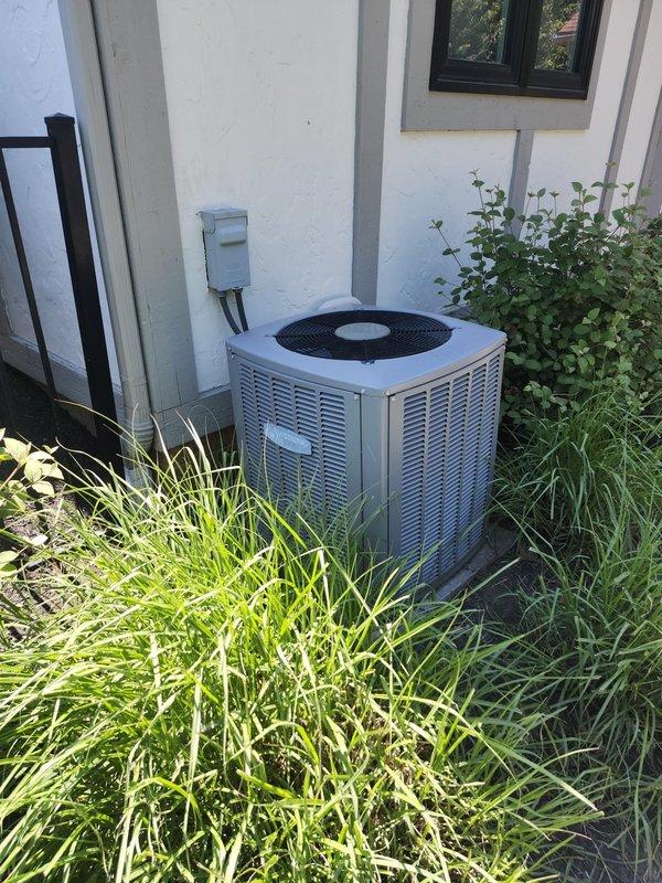 Completed AC retrofit installation including new outdoor condensing unit and indoor evaporator coil. Installed condenser on exterior concrete pad with proper clearances from landscaping and building structure, established refrigerant line connections, and verified electrical service to unit. Mounted new evaporator coil in interior space with copper refrigerant lines routed through ceiling joists, completed condensate drain connections using PVC piping, and ensured proper airflow integration with existing ductwork. System tested and operational with all components functioning within manufacturer specifications.