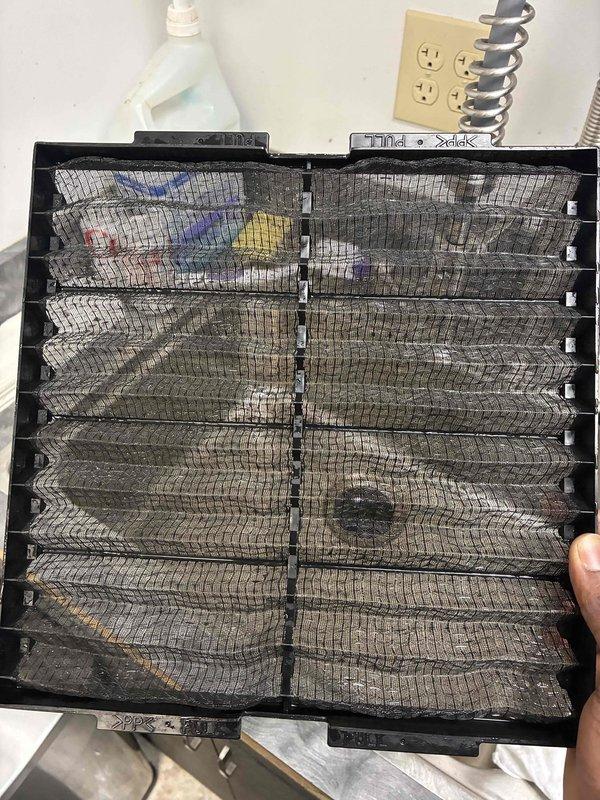 Completed scheduled commercial filter maintenance visit. Removed and replaced heavily soiled HVAC air filters showing significant particulate accumulation and debris buildup across all mesh sections. Installed new KOCH brand pleated filters with proper dimensional specifications in return air vents. Documented pre- and post-service conditions with photographs showing extent of contamination on removed filters and proper installation of replacement units within metal housing and ductwork assembly.