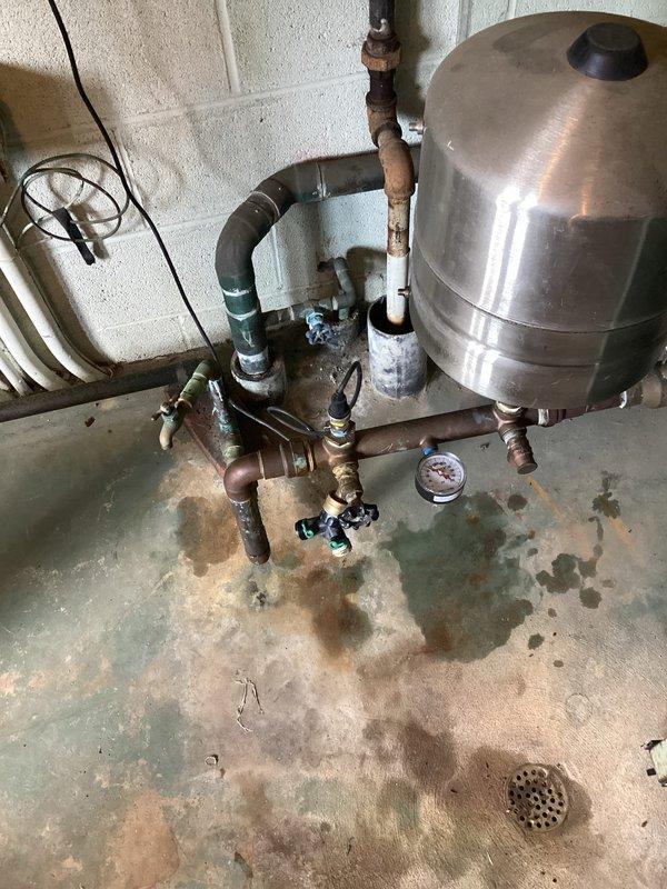 Performed pressure inspection of residential well water system. Examined pressure tank, associated plumbing connections, and pressure gauge which indicated system was functioning within normal operating parameters. Documented system configuration including stainless steel pressure tank, copper piping network, valves, and fittings for maintenance records.