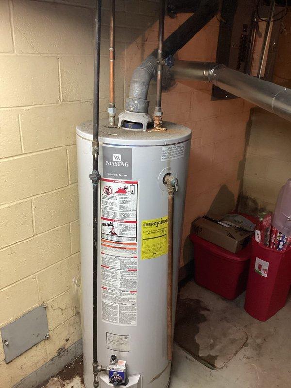 Conducted on-site assessment of existing Maytag tanked water heater system to provide replacement quote. Documented current unit condition through photographic inspection, noting significant corrosion and rust deterioration at pipe connection points near the base of the tank. Evaluated all plumbing connections including copper supply lines, galvanized steel piping with shutoff valve, and vertical discharge piping showing advanced oxidation. Coordinated scheduling with property owner for site access and completed comprehensive visual inspection of mechanical room infrastructure to determine replacement specifications and installation requirements.