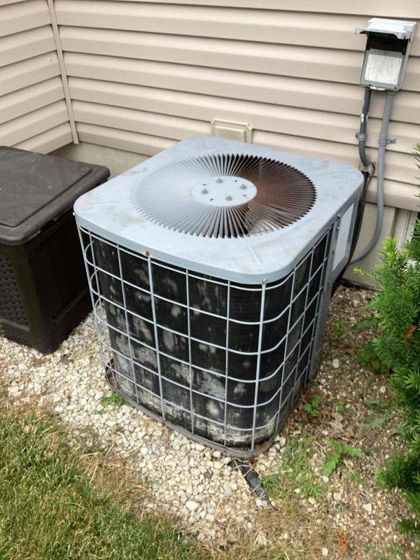 Responded to service call for frozen air conditioning unit. Upon arrival on rescheduled appointment, performed visual inspection of outdoor condensing unit and surrounding installation. Unit appeared operational at time of inspection with no visible ice accumulation present. Documented equipment condition and installation setup including proper gravel base drainage, adequate clearances, and secure mounting. System components including condenser coils, fan assembly, and protective grilles showed normal wear consistent with outdoor exposure.